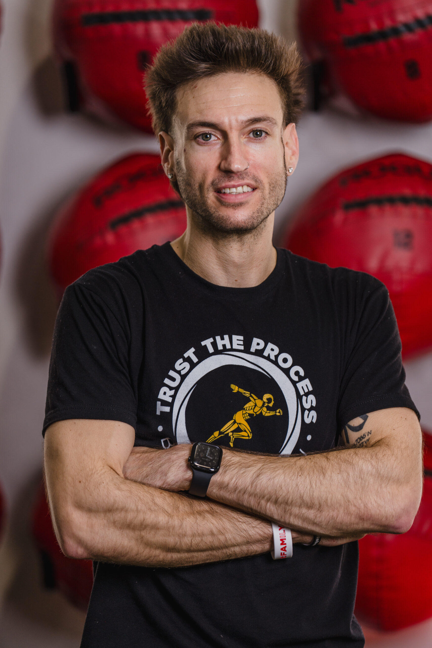 Personal trainer in Pflugerville, Cade standing confidently with arms crossed